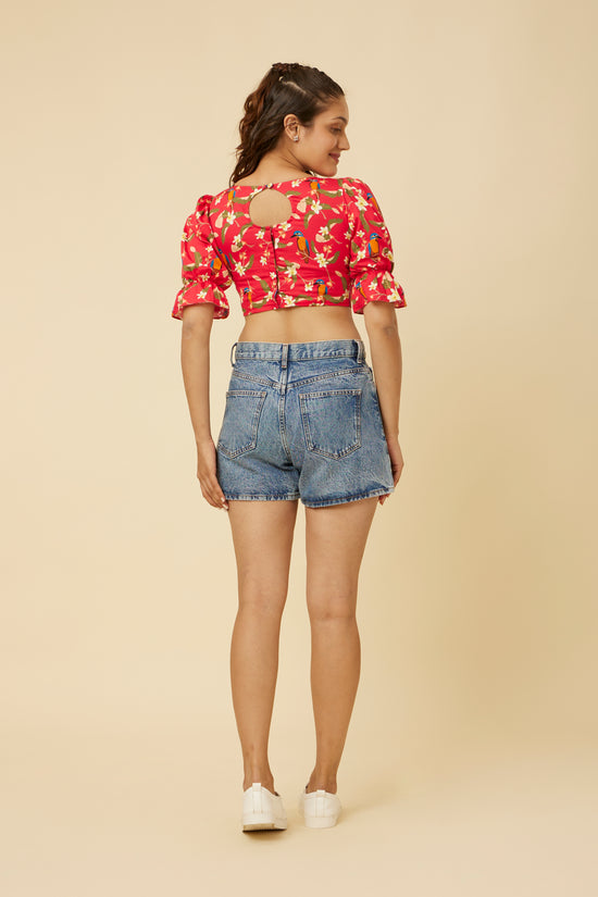 Rear view of the Crimson Summery Crop Top featuring a round cut-out back with an open design, offering a peek at the modern style that contrasts with the traditional puff sleeves and frills.