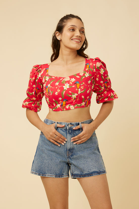 Close-up of the Crimson Summery Crop Top highlighting the sharp sweetheart neckline and long puff sleeves with elastic frills against the vibrant floral pattern, embodying chic elegance with a modern twist.
