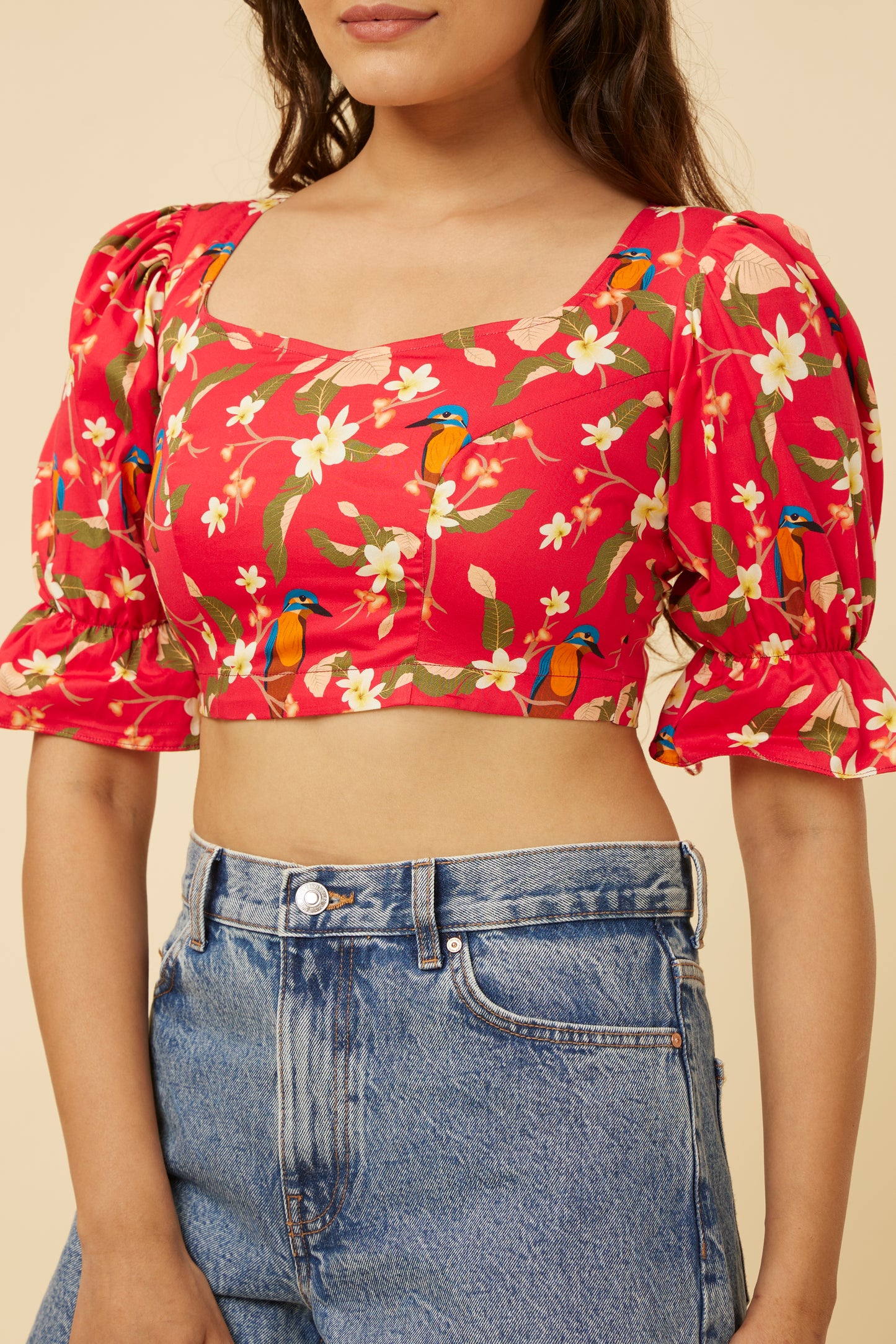 Detailed close-up of the Crimson Summery Crop Top’s sweetheart neckline and puff sleeves, the frills adding a touch of playfulness to the sophisticated floral and bird pattern.