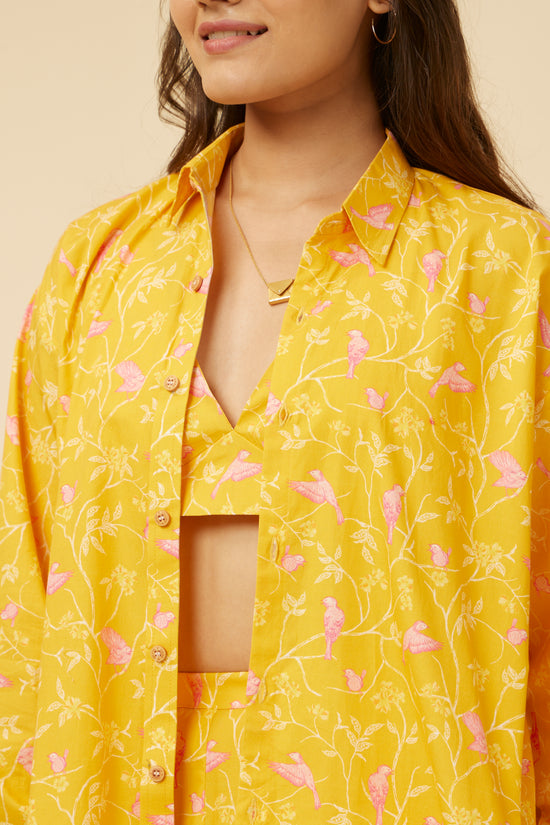 Close-up of the Peela Sunshine Full-Sleeve Shirt detailing the vibrant yellow fabric with pink leaf prints and the unique square cut-out neckline