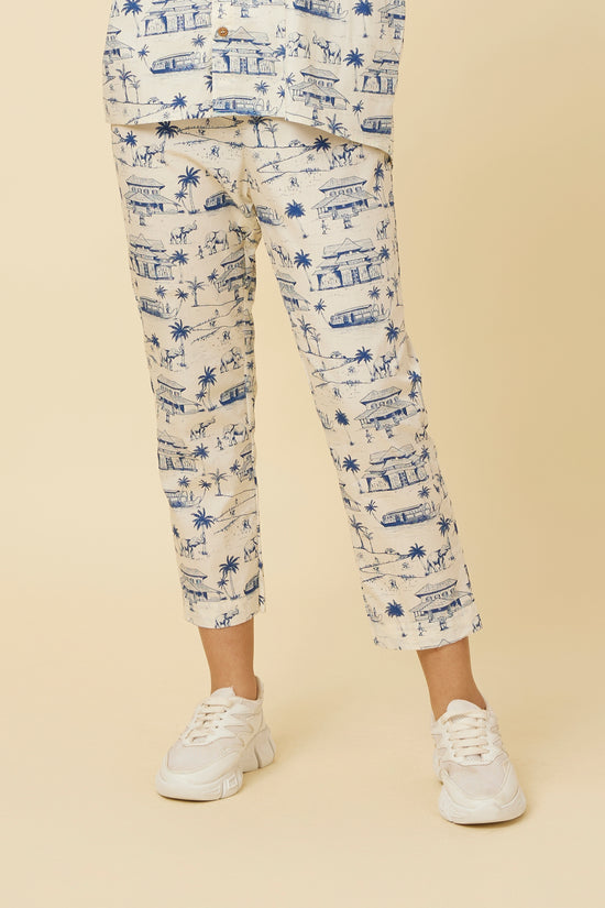 Close-up view of Homeland Pants featuring a classic straight hem, side pockets, and detailed Kerala print, paired with casual white sneakers