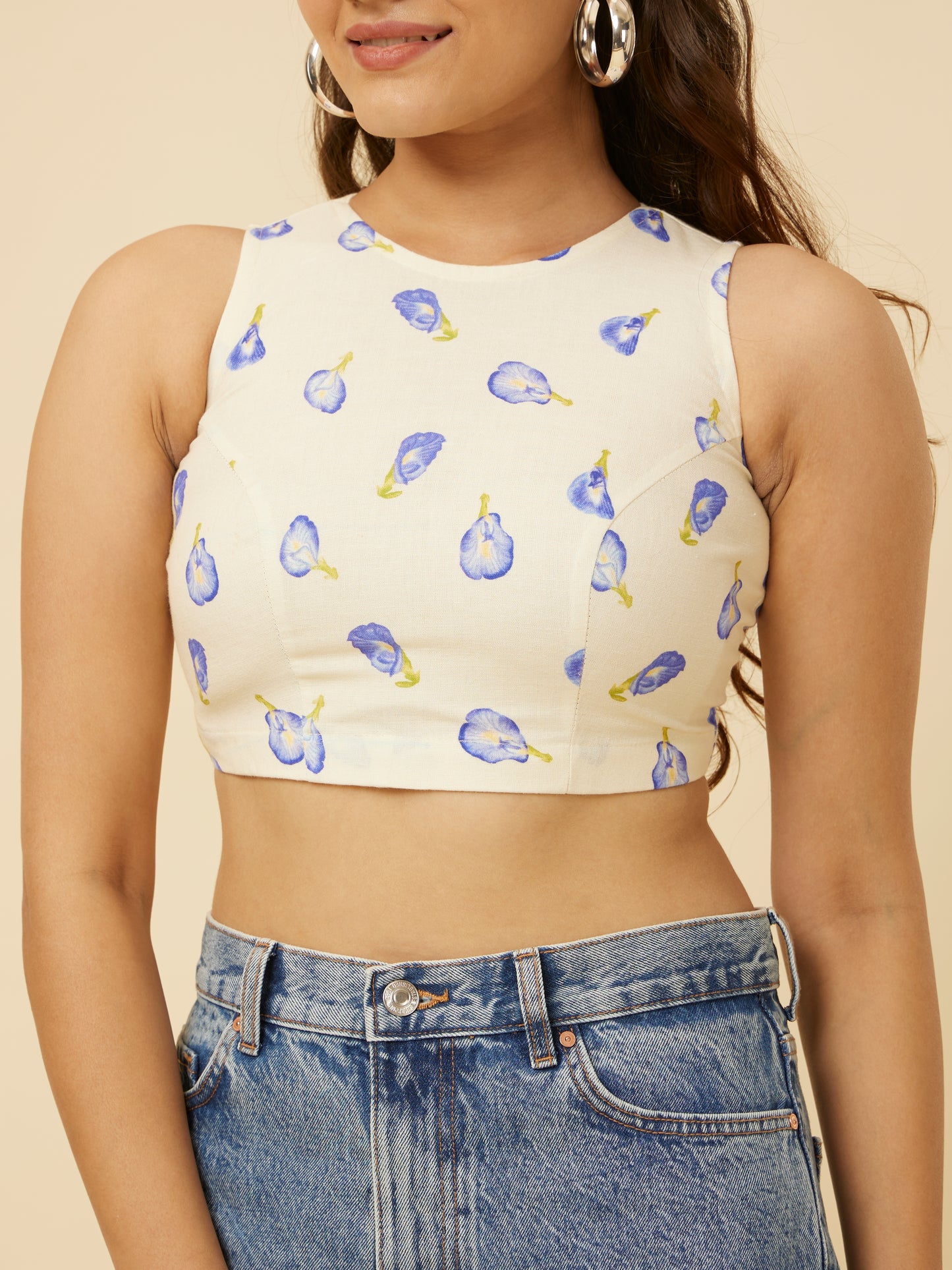 Detailed close-up of Hypsway’s Blue Pea Crop Top, showcasing the intricate blue pea pod design on a creamy fabric, highlighting the crop top’s fine texture and playful summer vibe for a fashionable day out.
