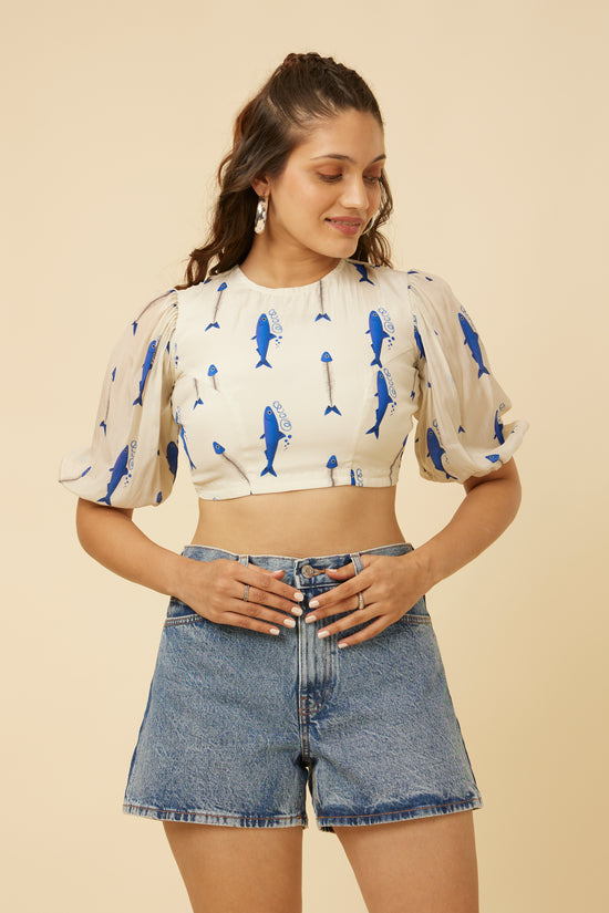 Close-up of the Voyager Crop Top with bandh neck and balloon sleeves, showcasing the blue fish print on an ivory background