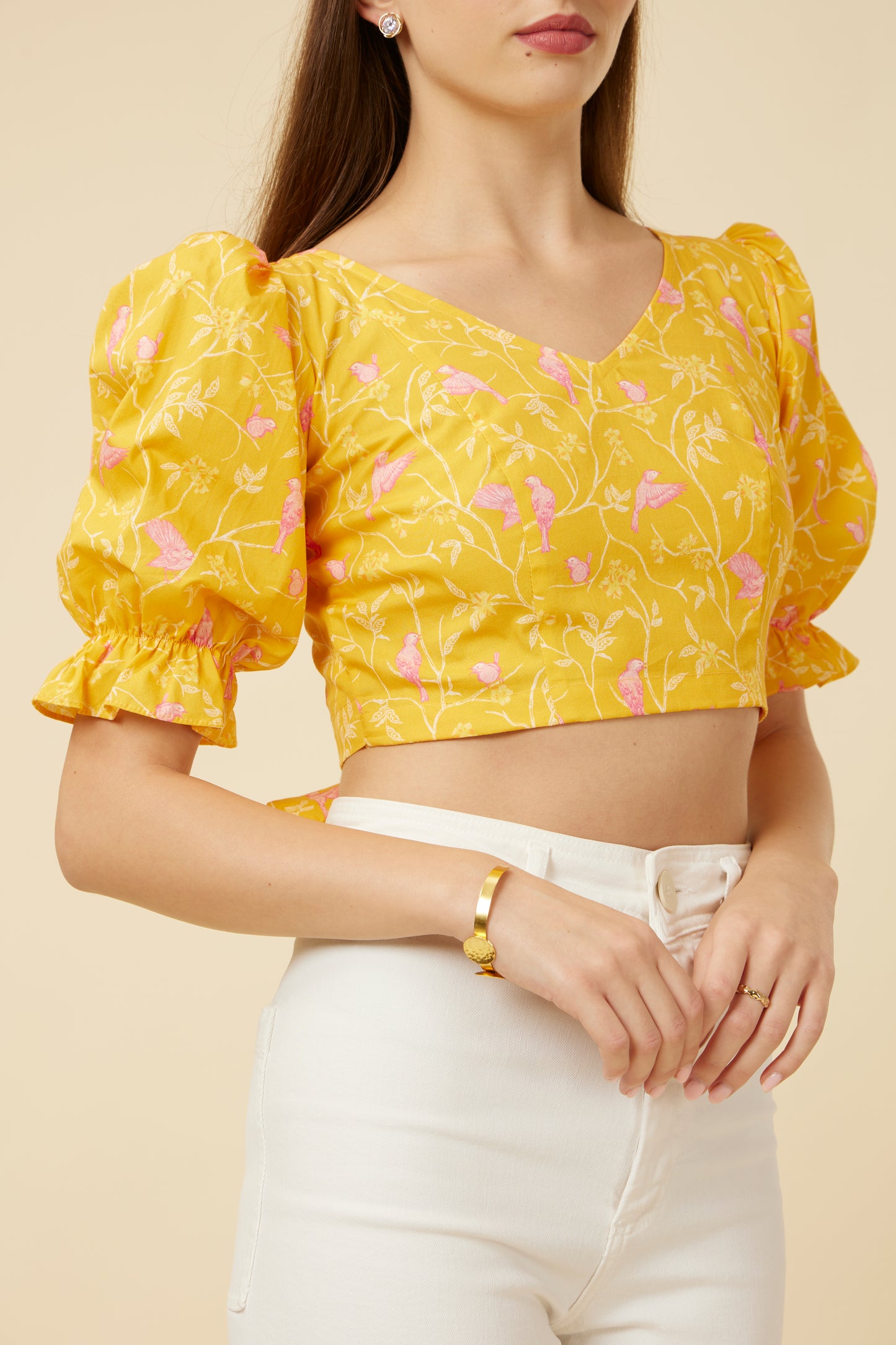 Close-up of the Peela Sunshine Crop Top's neckline and sleeve details, emphasizing the bright floral fabric and stylish design for personalized comfort