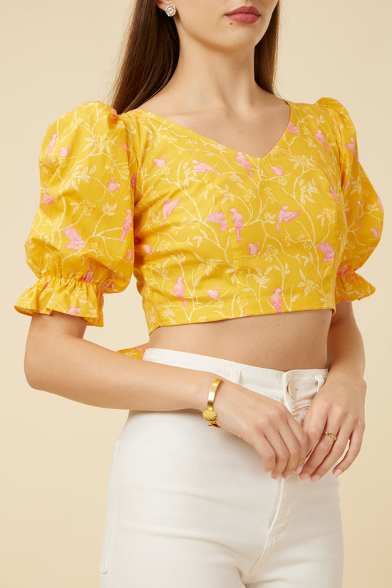 Close-up of the Peela Sunshine Crop Top's neckline and sleeve details, emphasizing the bright floral fabric and stylish design for personalized comfort