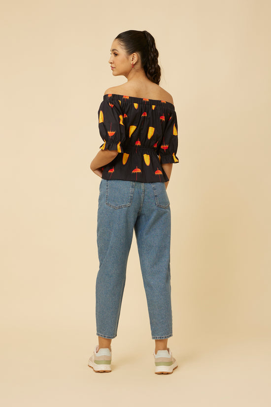 Rear view of the Spree in Black Off-Shoulder Top, focusing on the elastic design and unique back silhouette, paired with casual denim