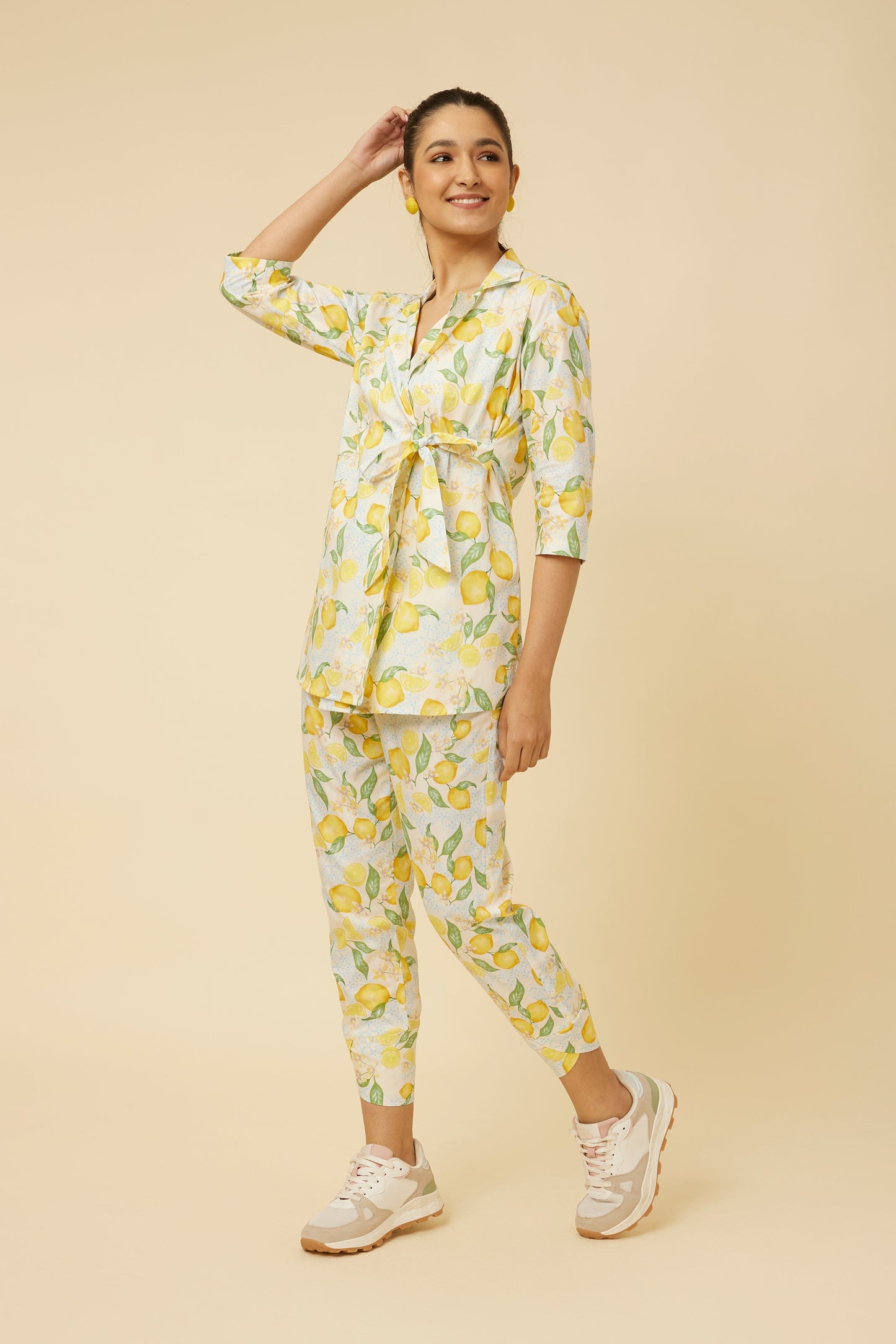 Model wearing the complete Citrus Dream set with full-sleeve shirt and fitted pants, illustrating the cohesiveness of the lemon tile print and the ensemble's modern flair with an innovative side-tie design.