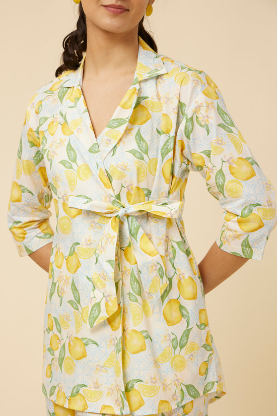 Close-up of the Citrus Dream Full-Sleeve Shirt featuring a lively lemon tile print on white, a unique shirt-jacket hybrid style, and an innovative side-tie design offering a refreshing twist to a classic silhouette.