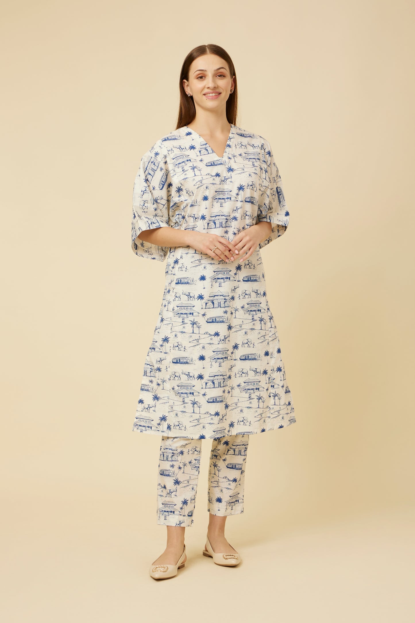 Model showcases the Homeland Kurta & Pants Co-Ord Set featuring a white base with indigo blue Kerala print, kimono sleeves, and a V-neck, paired with straight-cut pants