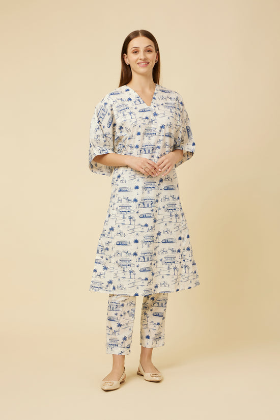 Model showcases the Homeland Kurta & Pants Co-Ord Set featuring a white base with indigo blue Kerala print, kimono sleeves, and a V-neck, paired with straight-cut pants