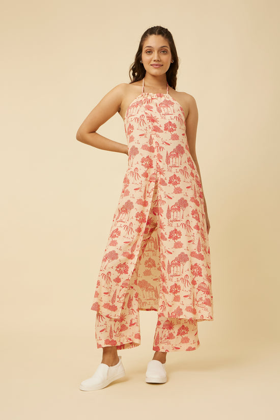 Side view of the Jaipur Rani mid-length dress showcasing the flow of the A-line silhouette and the detailed traditional print, model looking to the side with a neutral background