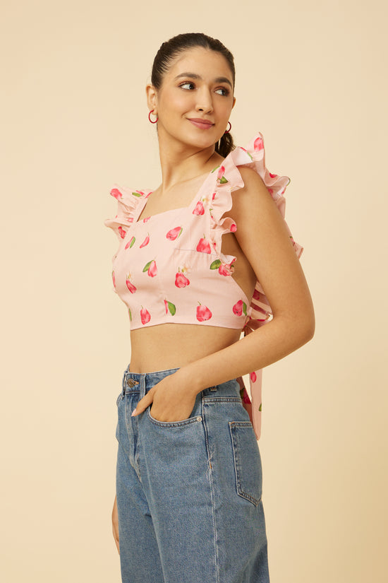A model posing in a Rose Apple Frill Crop Top with square neckline and frill shoulder accents, paired with high-waist denim jeans