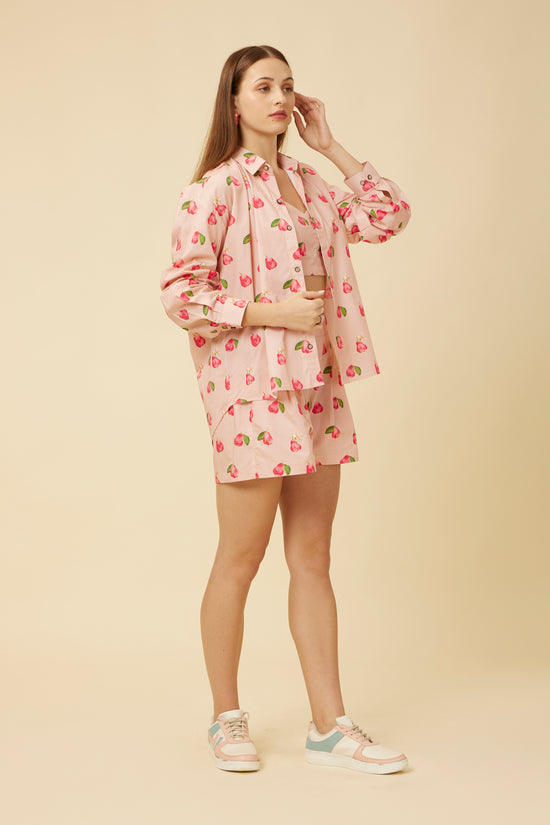 Front view of a woman in a Rose Apple printed shirt and shorts Co-Ord Set, showcasing the full sleeves and button-up design
