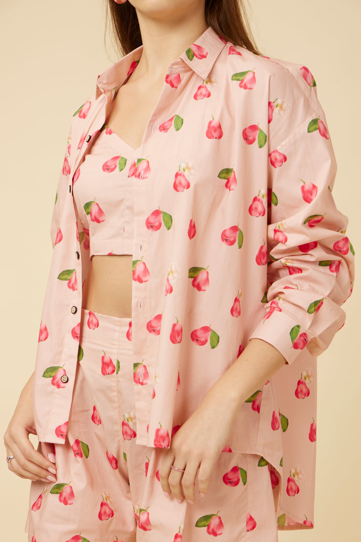 Close-up of a woman wearing the Rose Apple full-sleeve shirt, showing the detailed rose print and the chic square neckline
