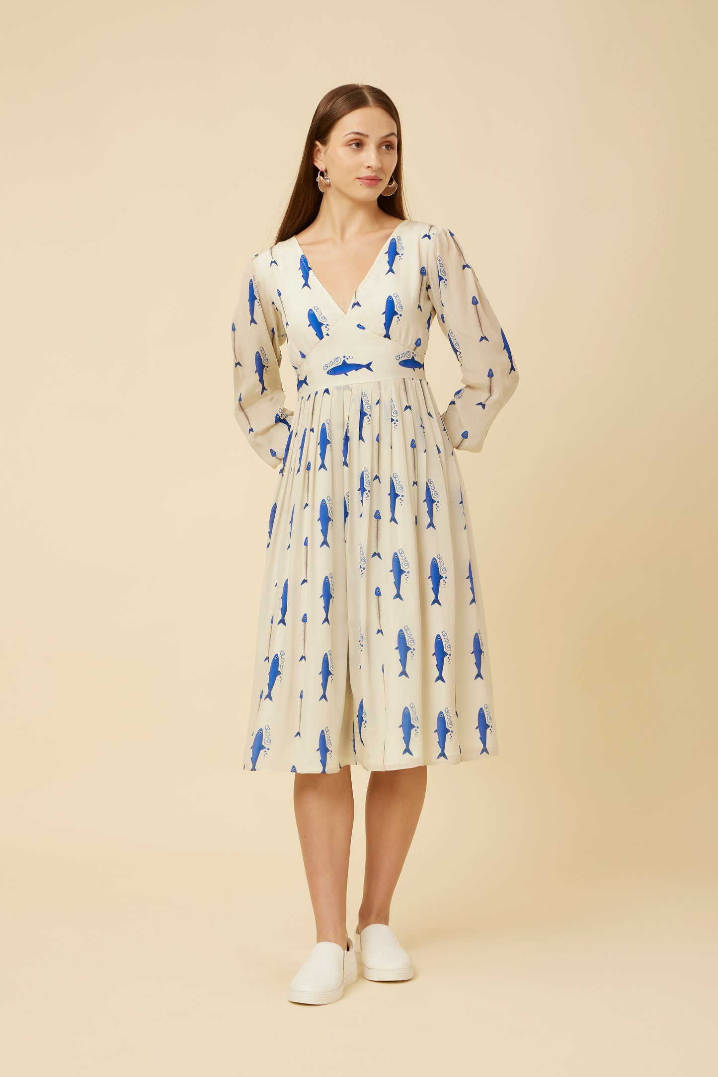 Front view of the model in the Voyager Dress highlighting the elegant yoke cut, three-quarter sleeves, and dynamic sardine run print