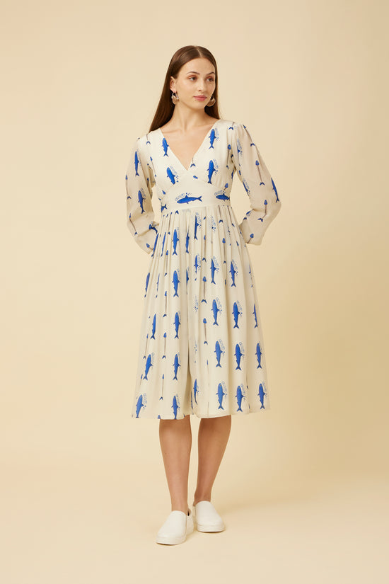 Front view of the model in the Voyager Dress highlighting the elegant yoke cut, three-quarter sleeves, and dynamic sardine run print