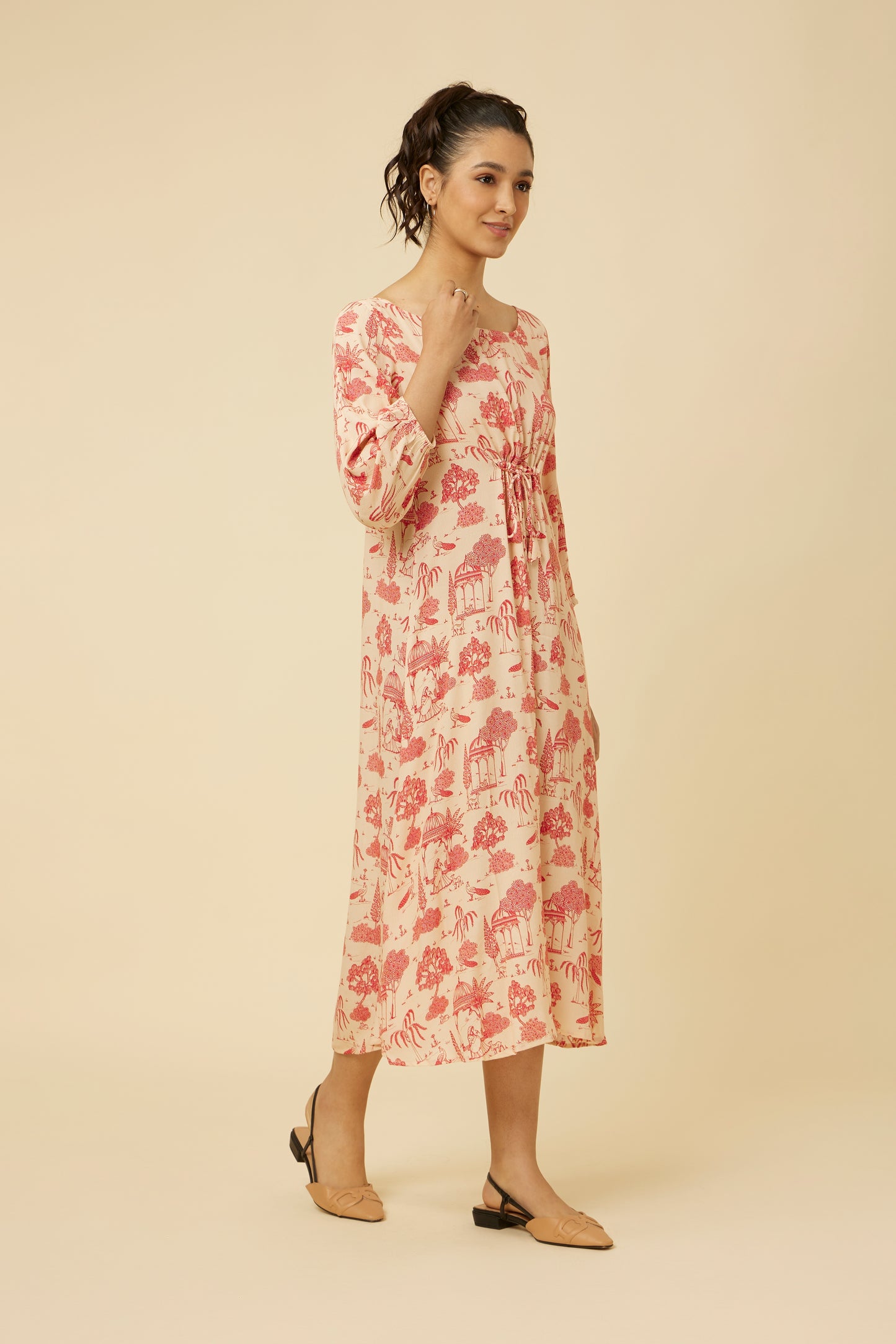 Side angle of pink bhutta printed Jaipur Rani dress with a flattering cinch at the waist and relaxed three-quarter sleeves