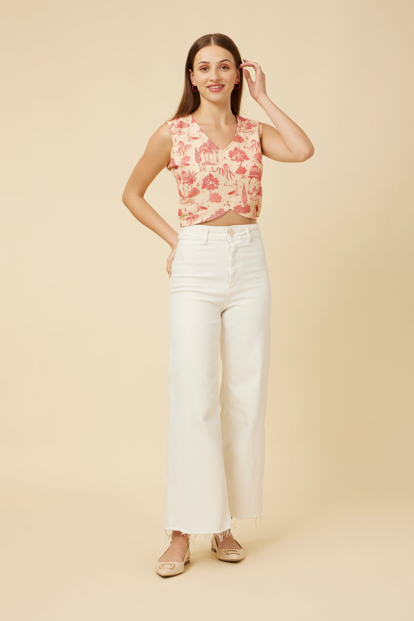 Frontal view of the model in the 'Jaipur Rani' sleeveless crop top, paired with white pants, highlighting the V-neck and intricate Jaipur print