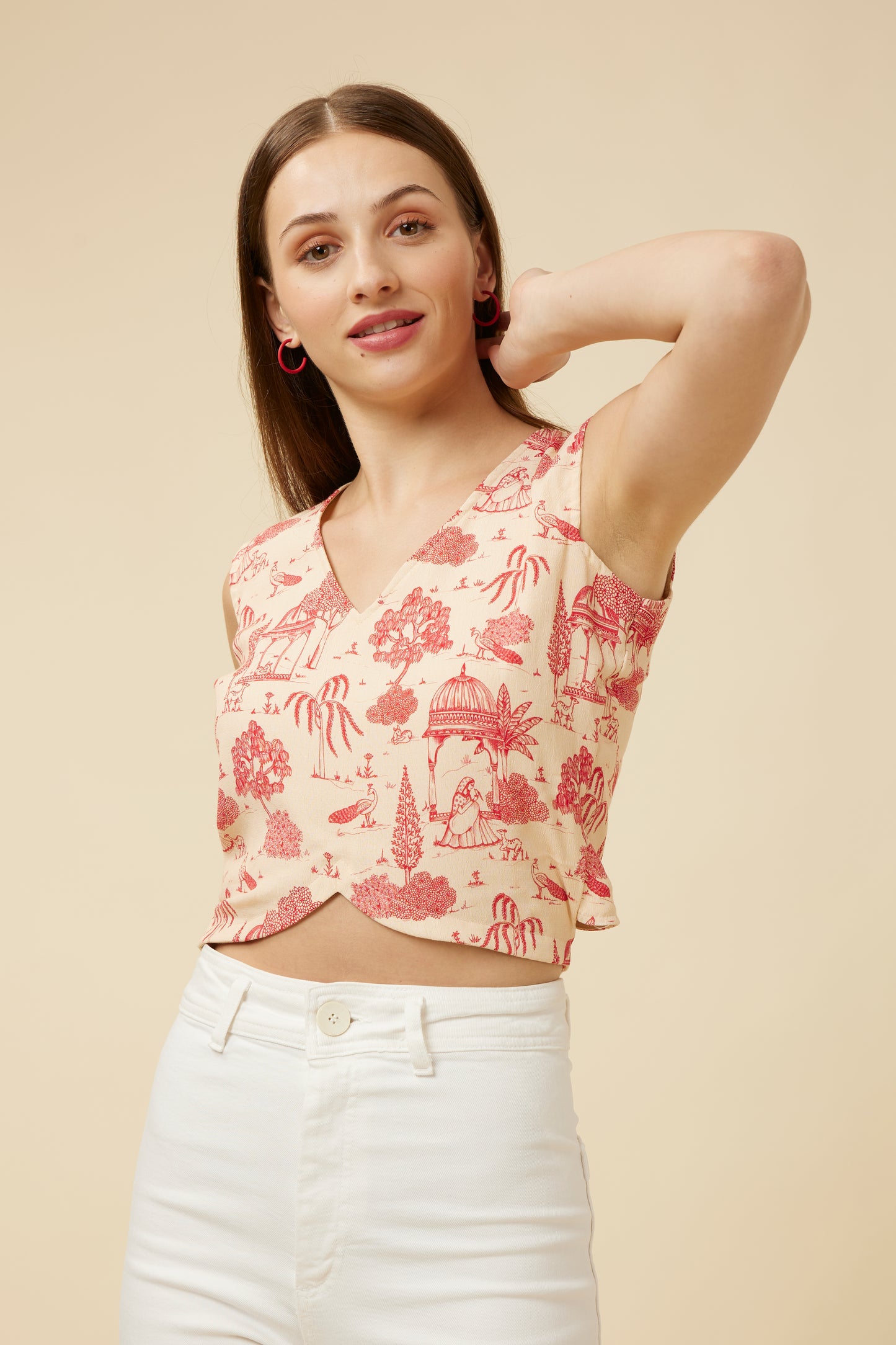 Model poses with hand behind head, showcasing the 'Jaipur Rani' crop top with V-neck front in a Jaipur-inspired print