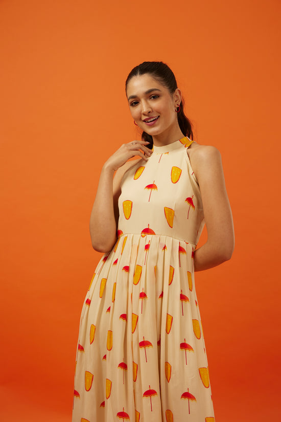 Graceful woman in a Hypsway designer dress featuring a playful popsicle print on a creamy yellow backdrop with a high neckline and pleated waist, presenting a fresh and delightful summer look, ideal for the fashion-forward young woman with a penchant for fun, yet chic attire.